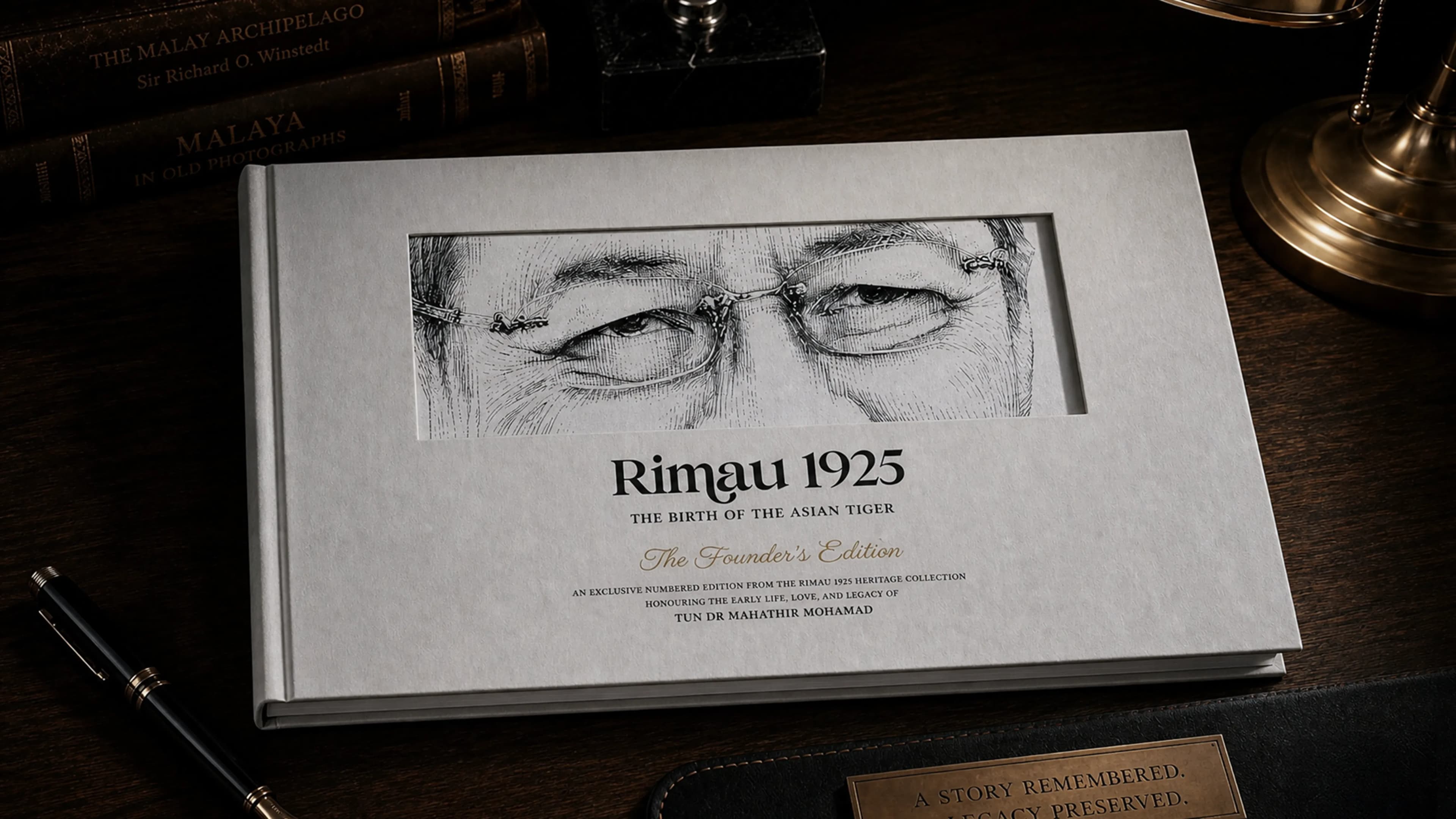 RIMAU 1925 The Founder's Edition — a numbered hardcover collector's publication resting on a desk beside a fountain pen.